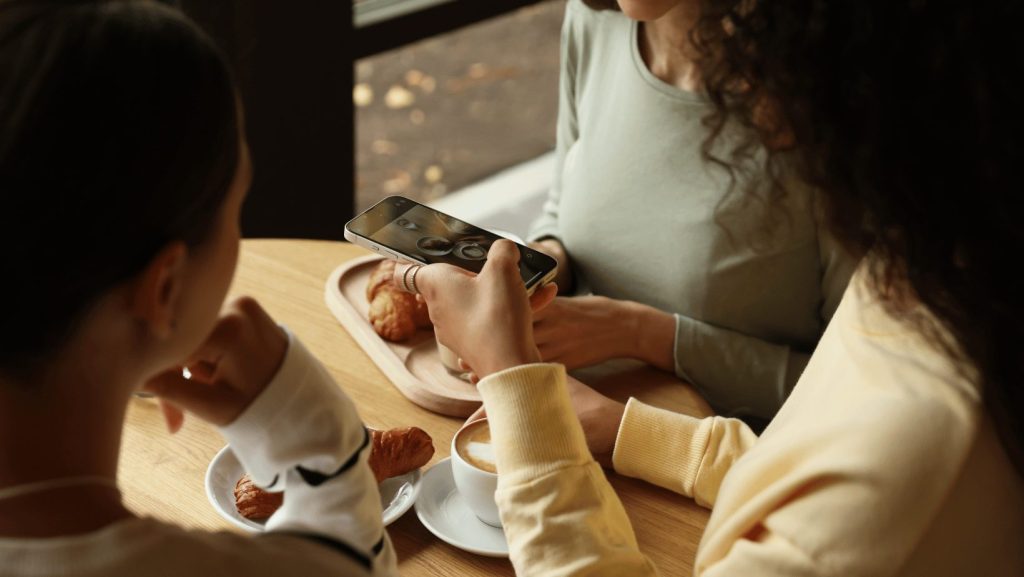 woman taking an instagram photo at a coffee shop